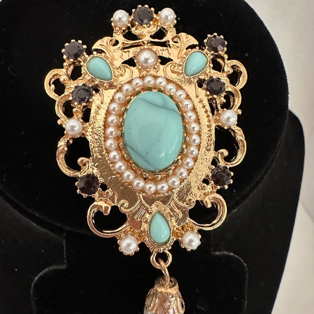Gold tone with faux turquoise rhinestone brooch